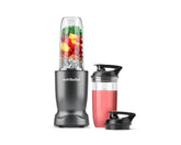 nutribullet Turbo blender in gunmetal gray with a filled blending cup, smoothie cup, and travel lid