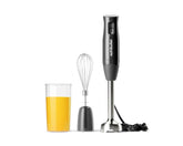 The nutribullet Lite immersion blender shown with a whisk attachment, blending arm, and mixing cup filled with orange juice.