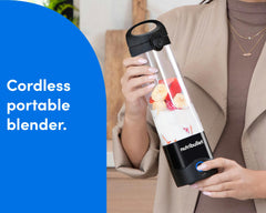 A woman dressed in beige holds the nutribullet Portable Blender, filled with fruit and ice. A blue panel on the left reads: "cordless portable blender."