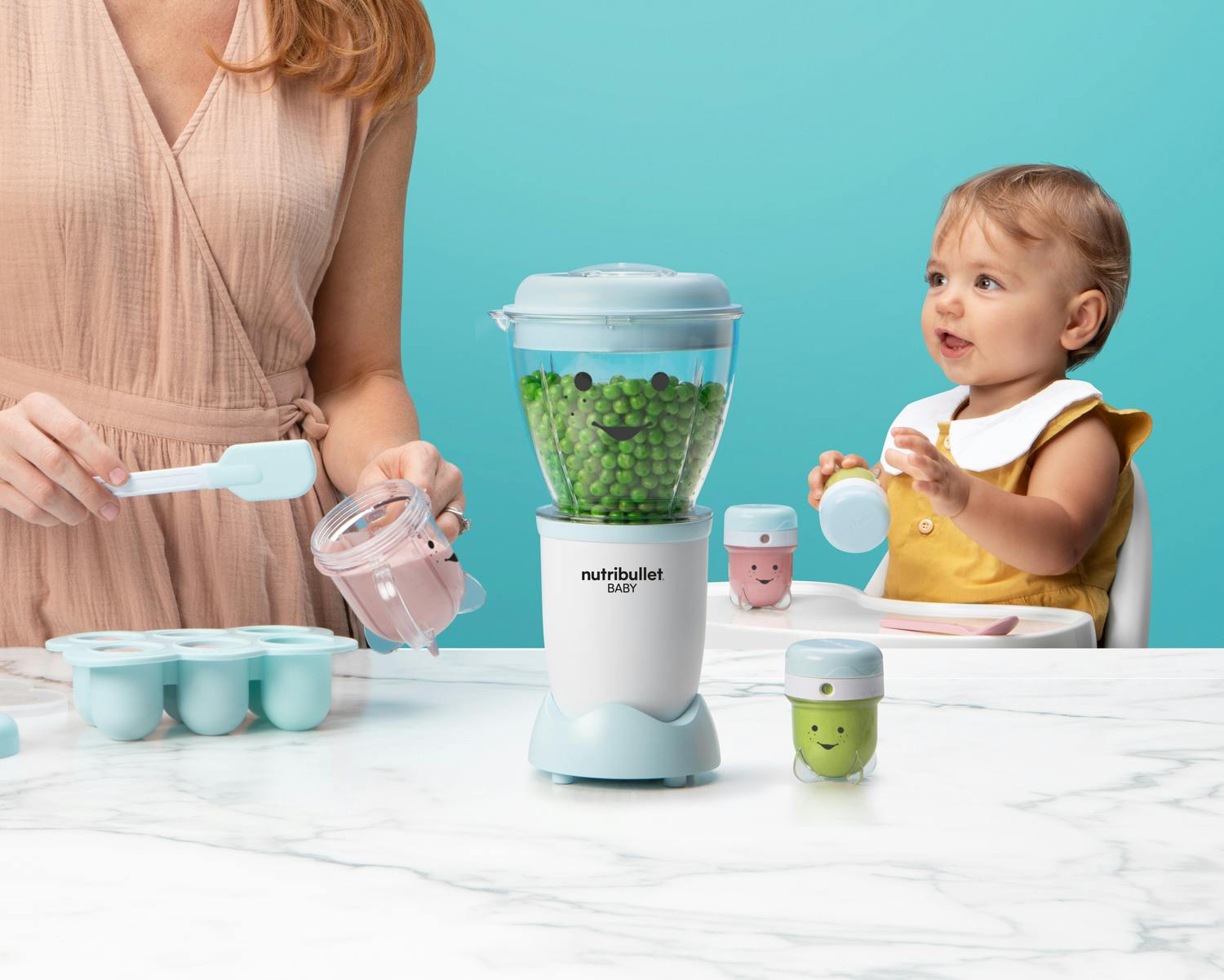 NutriBullet Baby with peas on blue background.
