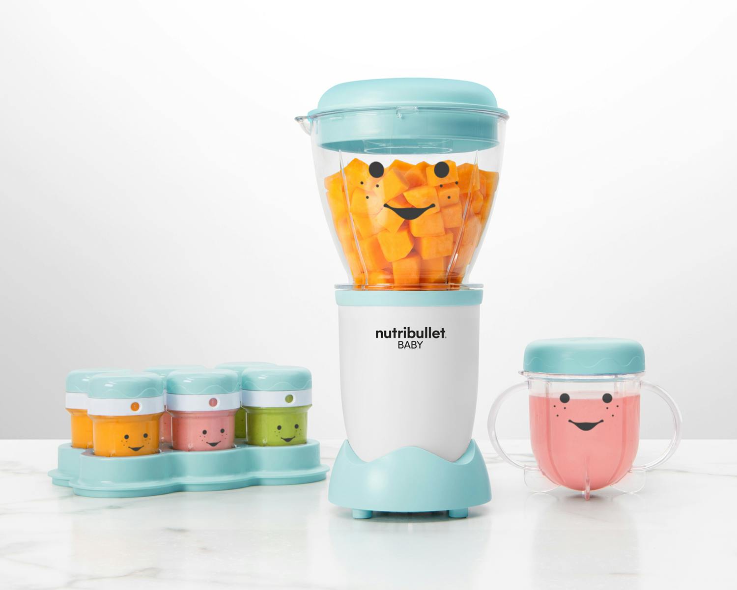 NutriBullet Baby with storage cups, lids, and purees on white background.