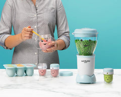 NutriBullet Baby with storage cups and easy pop freezer tray on blue background.