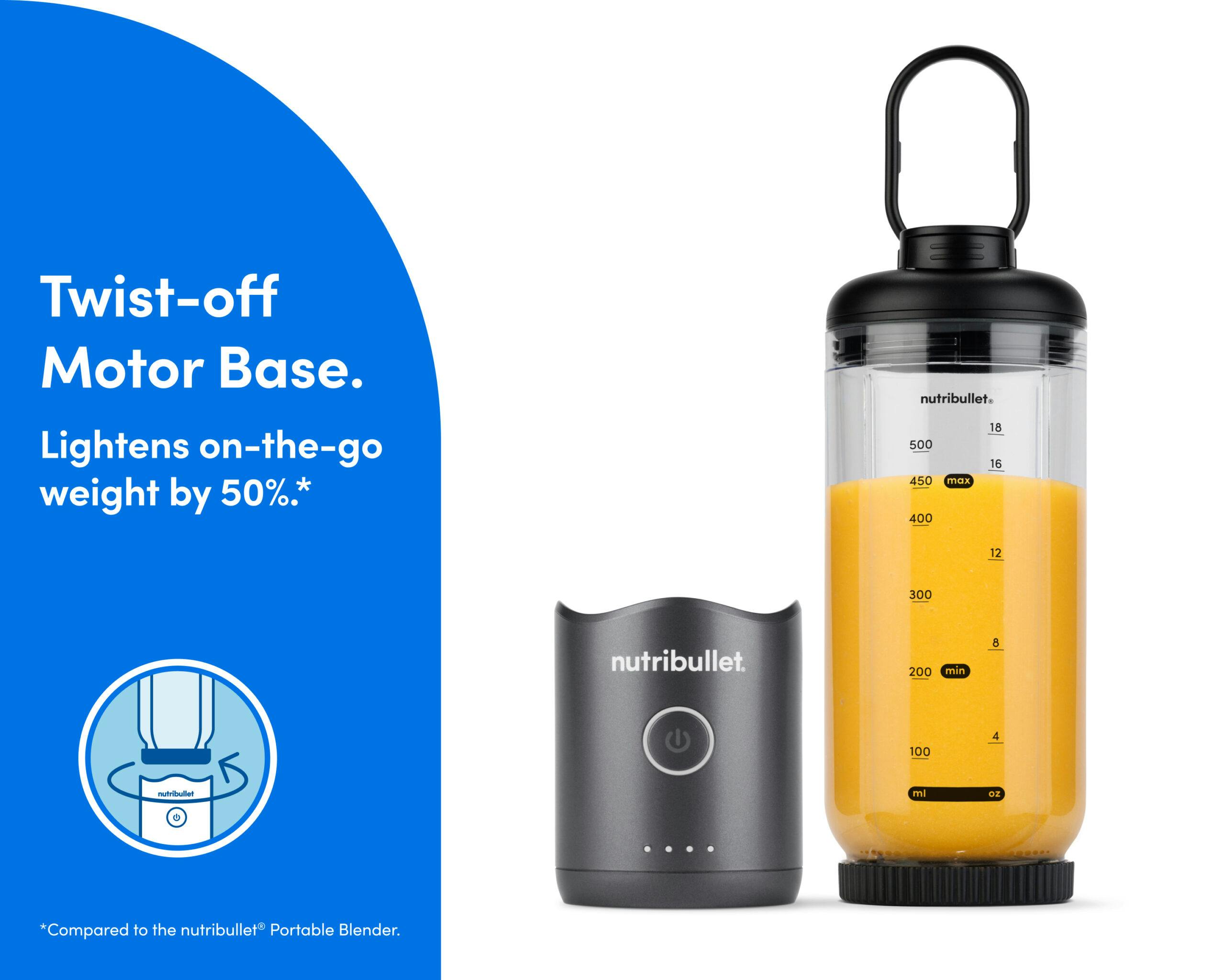 The motor base is detached and resting next to the blending cup. The cup is sealed on the bottom with the blade, and the lid is attached with the comfort handle extended.