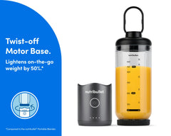 The motor base is detached and resting next to the blending cup. The cup is sealed on the bottom with the blade, and the lid is attached with the comfort handle extended.