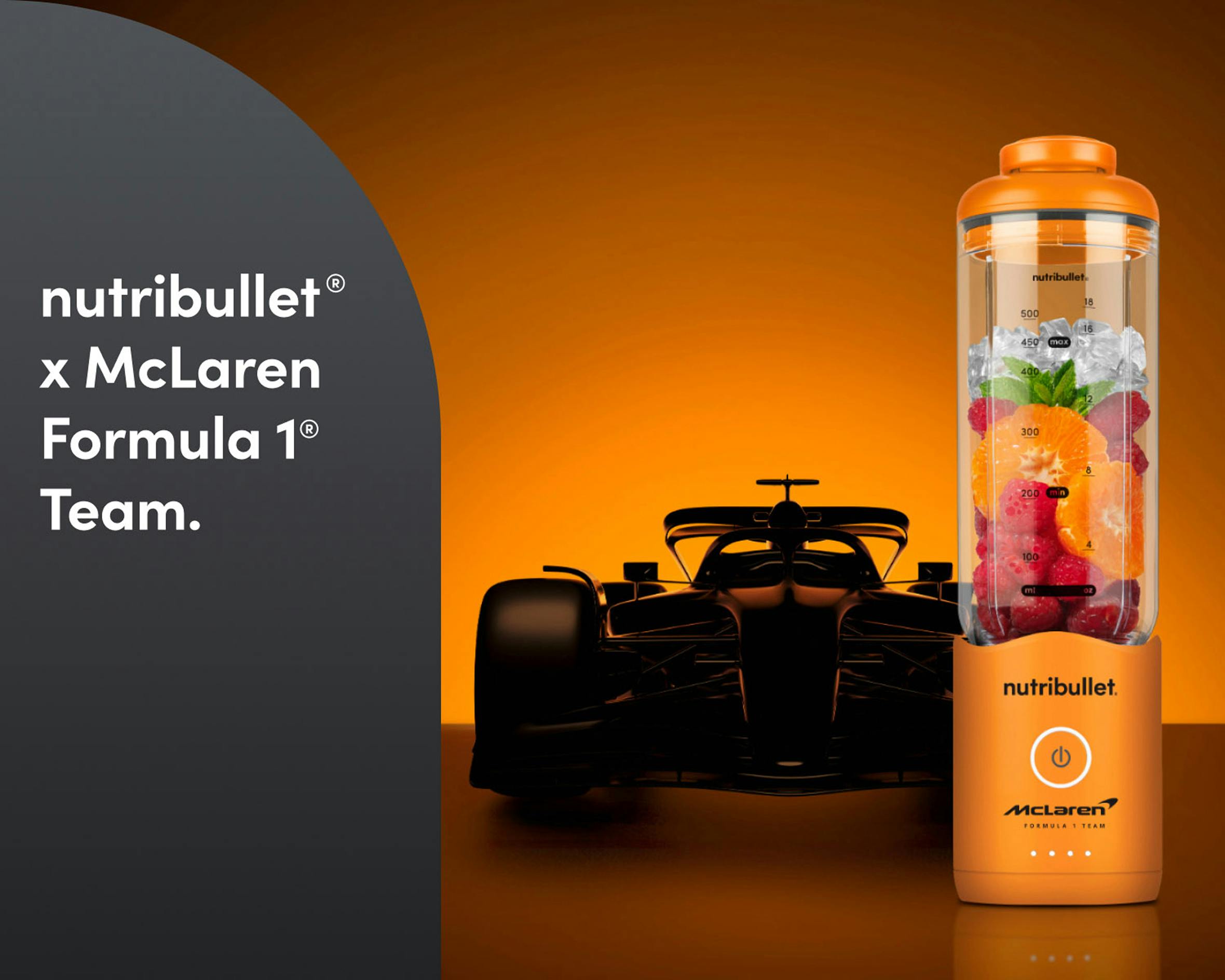 Dramatic scene highlighting the collaboration with a Formula 1–style car silhouette behind the blender.