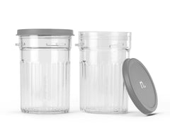 Two identical clear plastic ribbed cups, one with a grey lid on and one with its grey lid leaning against it.