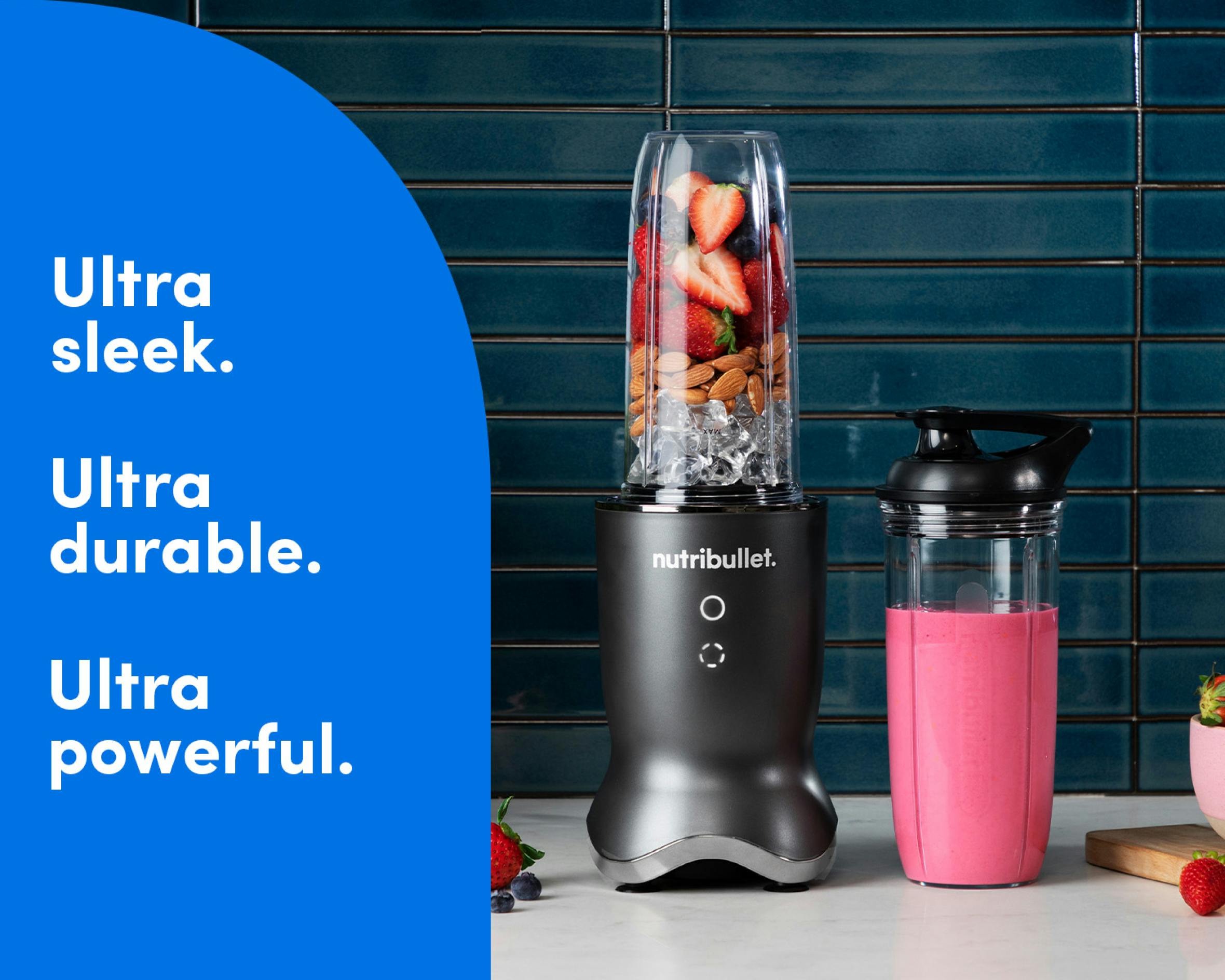 The gunmetal nutribullet Ultra rests on a kitchen counter filled with fruit, ice, and nuts. The nutribullet Ultra cup is next to it, filled with a pink smoothie. Text on the image reads: Ultra sleek. Ultra durable. Ultra powerful.