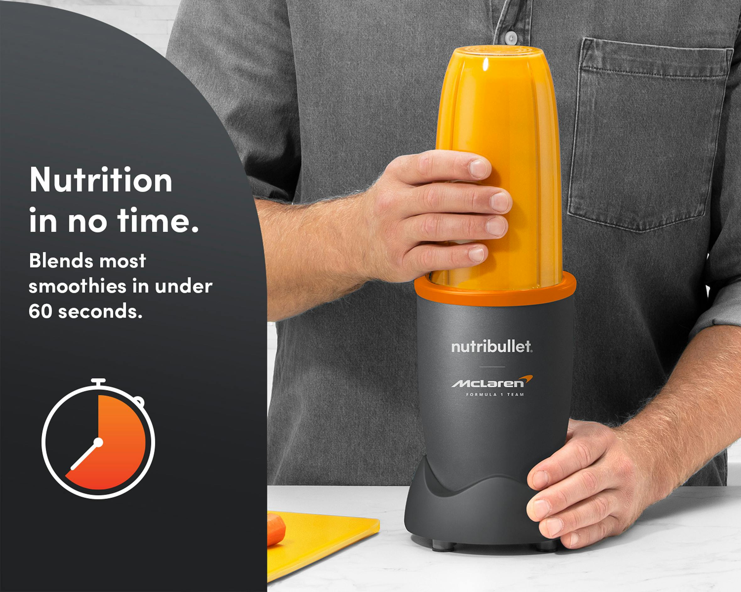 Closeup of hands using the nutribullet® x McLaren: Pro with an orange liquid. A gray panel reads "Nutrition in no time" with a corresponding icon below.