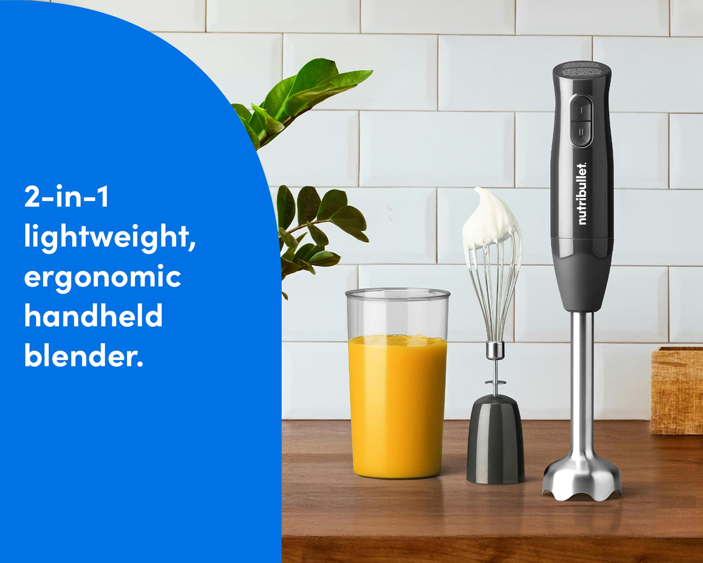 A nutribullet Lite handheld blender displayed on a kitchen counter beside a whisk, blending cup, and plant, emphasizing its compact, 2-in-1 design.