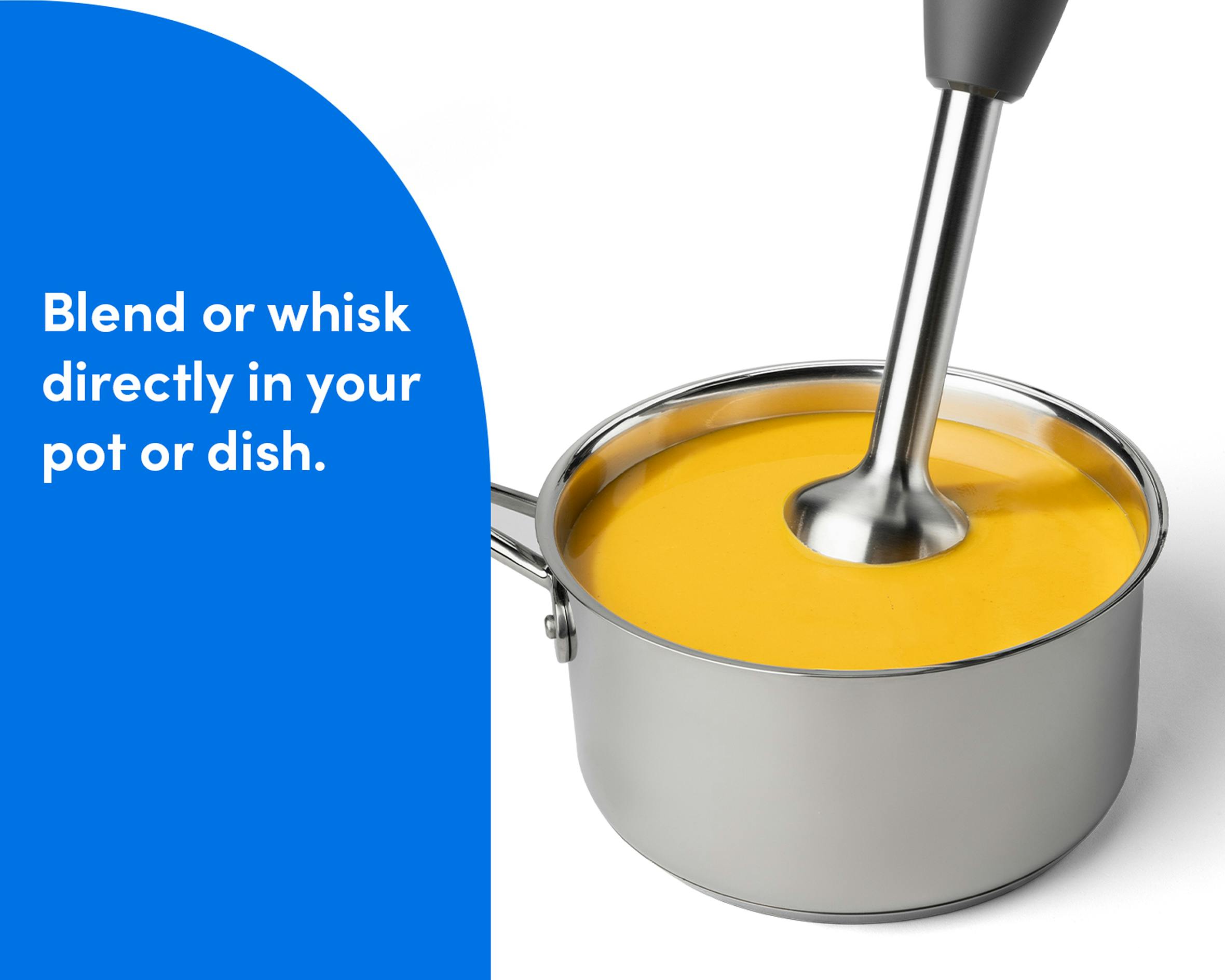 The nutribullet Lite immersion blender mixing a pot of orange soup, demonstrating its ability to blend ingredients directly in the dish.