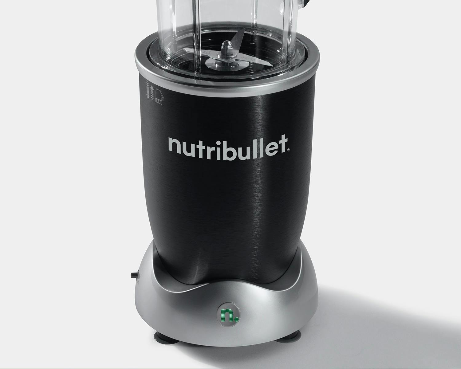 NutriBullet Rx 1700 watt motor base and extractor blade on grey background.