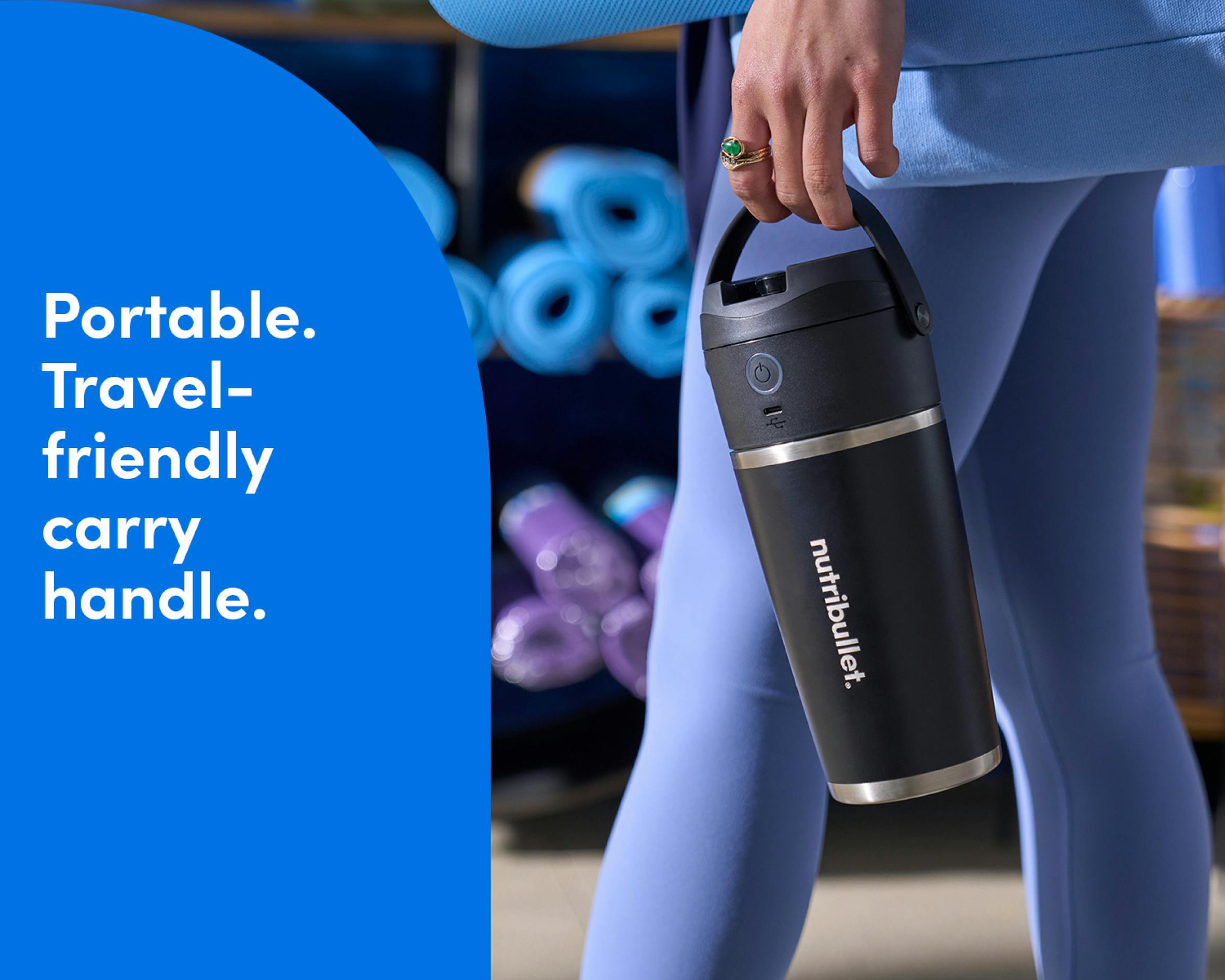 Woman holding the nutribullet Flip. Portable travel-friendly carry handle.