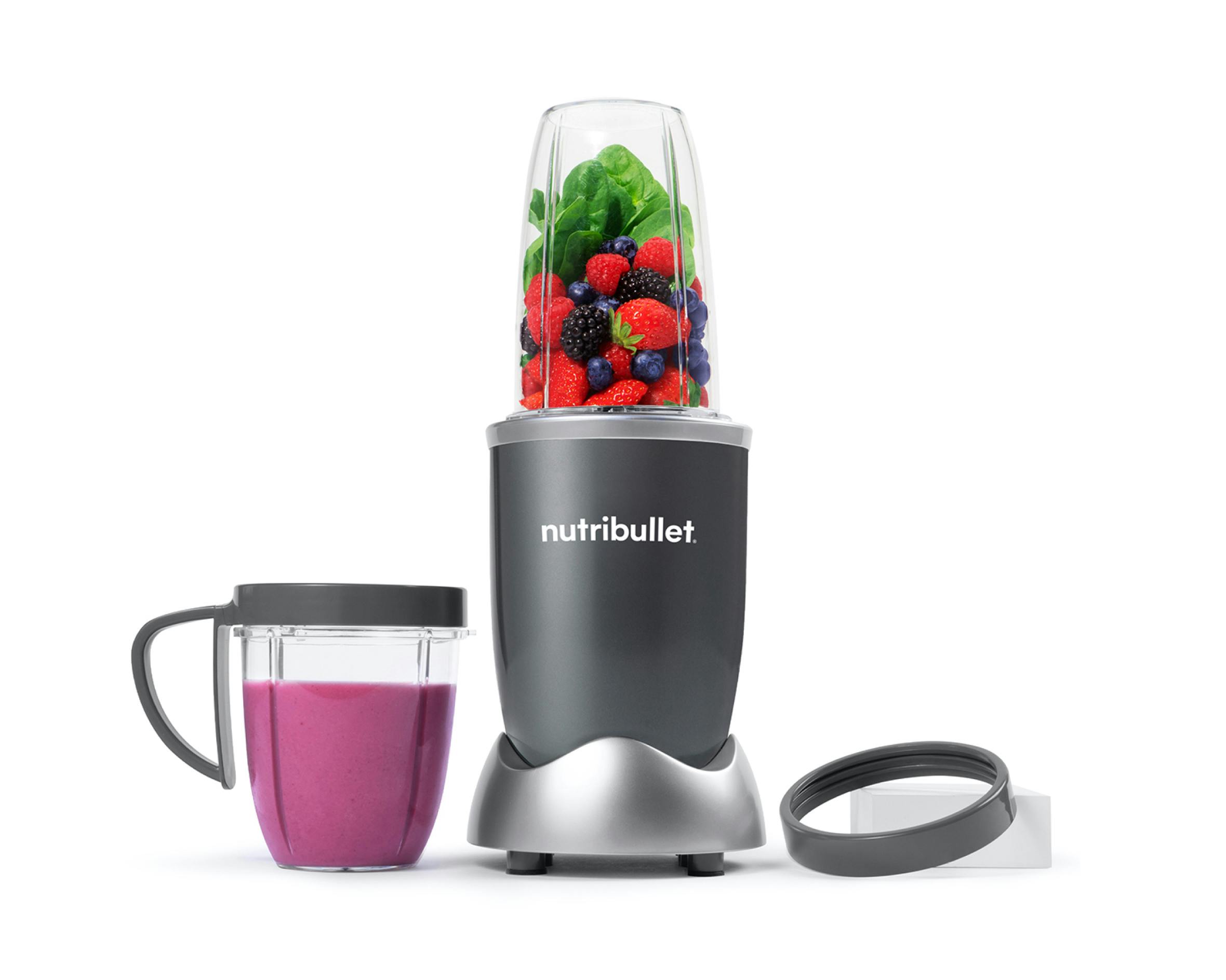nutribullet original with fruit and vegetables on white background.