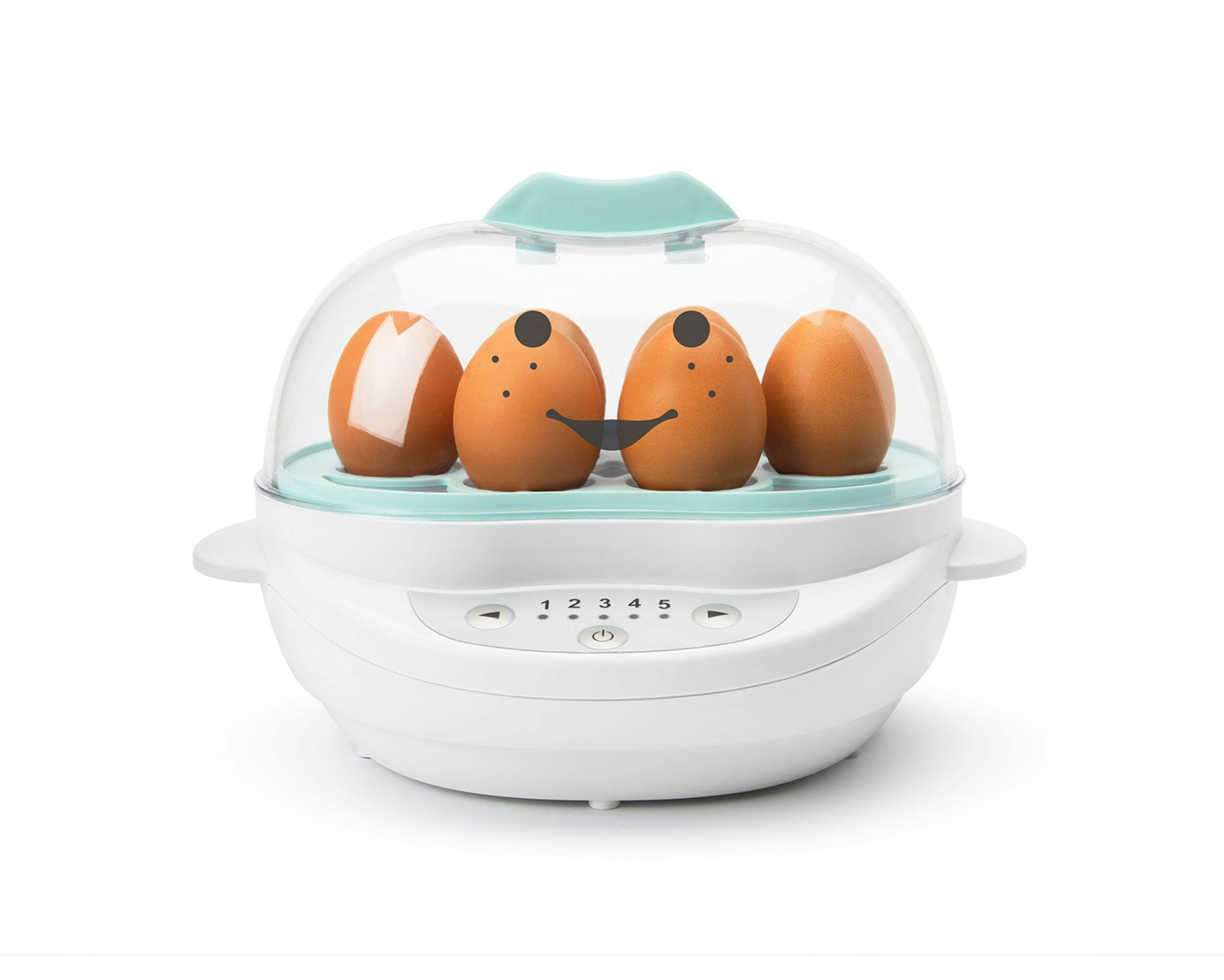White NutriBullet Baby Steamer filled with brown eggs with teal accents with smiley face