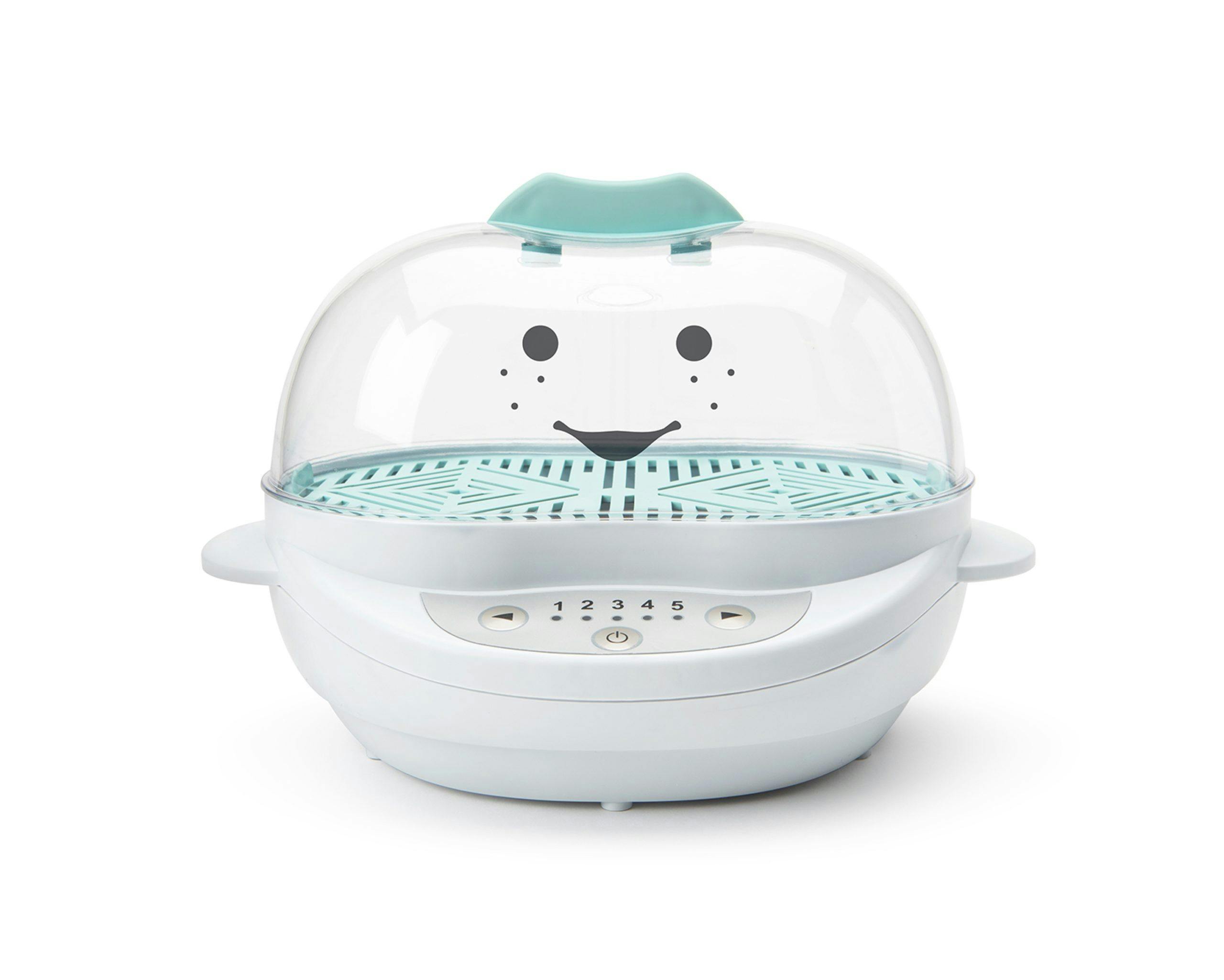Empty white NutriBullet Baby Steamer with teal accents with smiley face